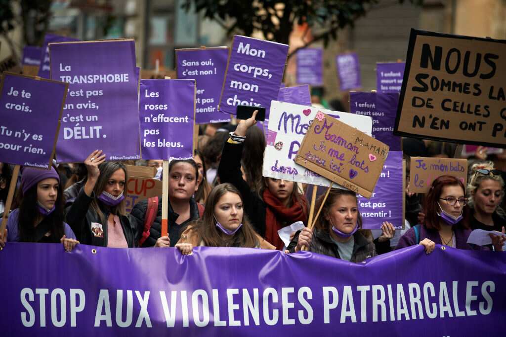 Women from the NousToutes collective hold a banner reading 'Stop patriarchal violence" at a protest in Toulouse against sexual violence and the patriarchy.