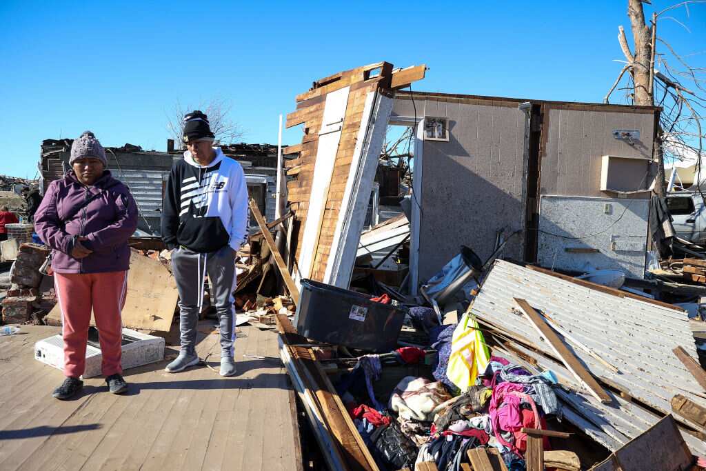 A family who lost their house is seen as tornado hit Mayfield, Kentucky, United States on December 12, 2021.