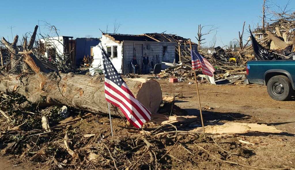 Marty Janes, 59, salvaged two American flags from his home, which was destroyed by a tornado on 11 December 2021.