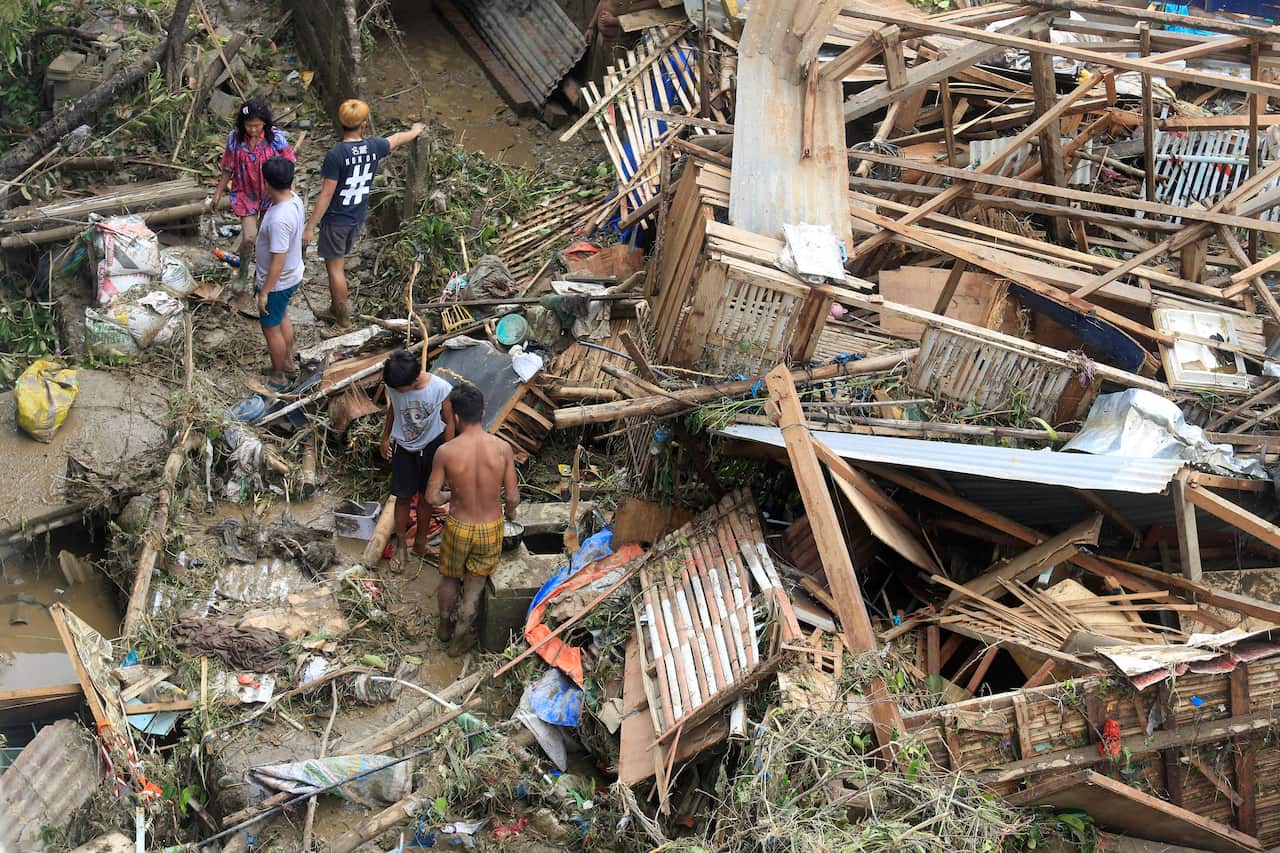 Residents salvage belongings from their destroyed houses at Talisay in Cebu province on December 17, 2021, a day after Super Typhoon Rai hit. (Photo by Alan TANGCAWAN / AFP) (Photo by ALAN TANGCAWAN/AFP via Getty Images)