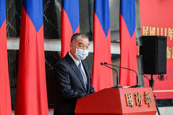 Taiwan's Defence Minister Chiu Kuo-cheng wearing a suit and face mask and standing at a lectern.