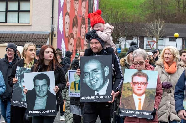 Family members carry photographs of those killed on Bloody Sunday at a memorial march in Derry, Northern Ireland.