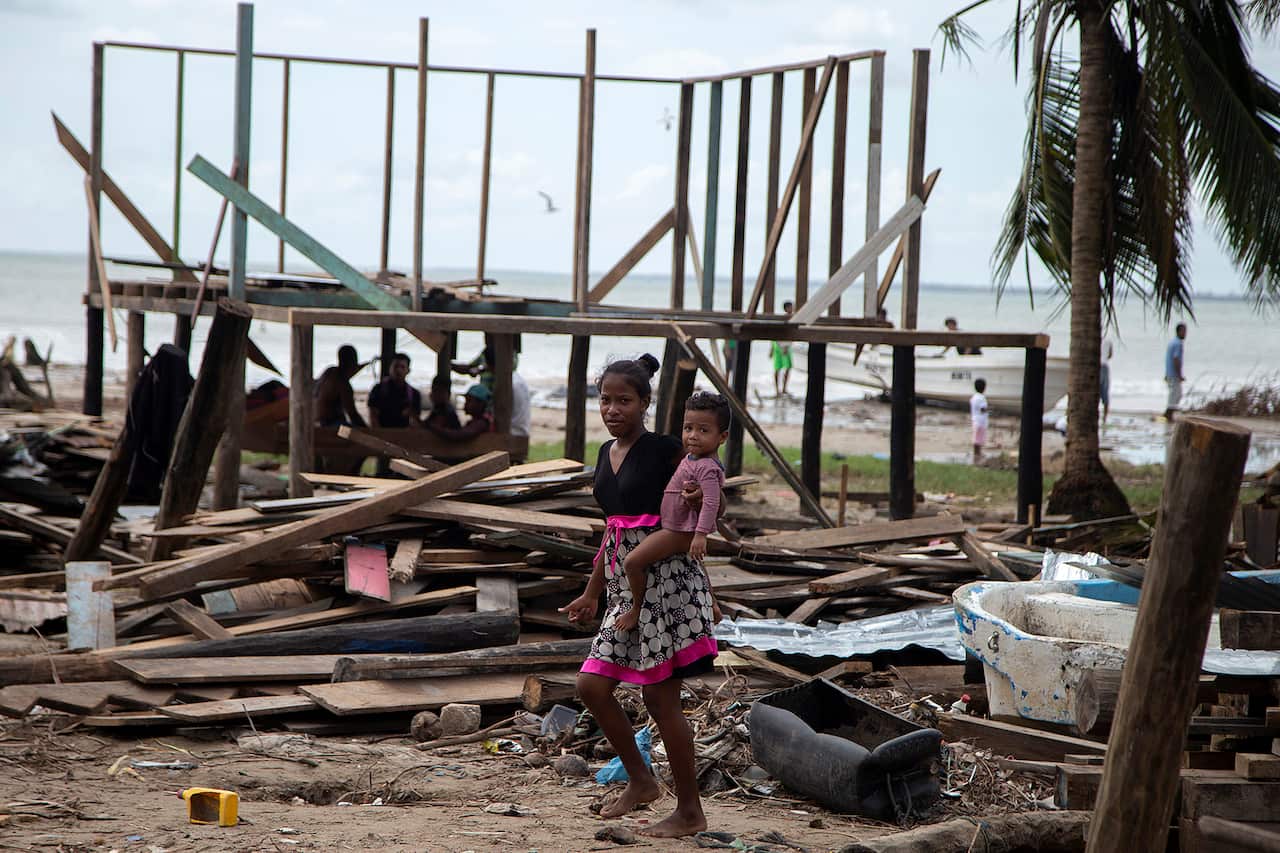 A woman in Nicaragua walks through her house destroyed by Hurricane Eta last month before the arrival of Hurricane Iota. 