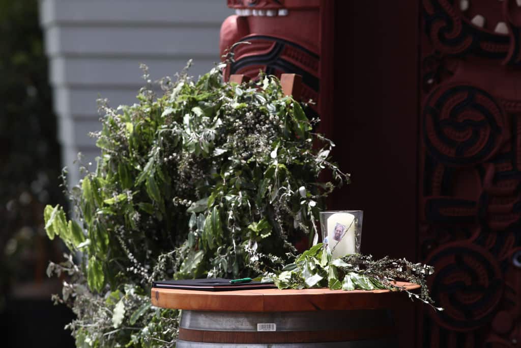 A photo of Hayden Marshall-Inman's is printed on a candle at the entrance to the Te Manuka Tutahi Marae for a memorial service in Whakatane, New Zealand. 