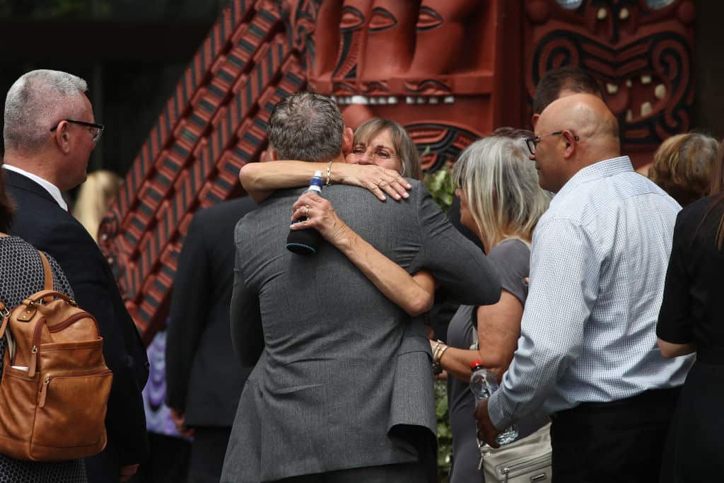 Friends and family of victims of the White Island eruption hug following the memorial service on 9 December, 2020 in Whakatane, New Zealand.