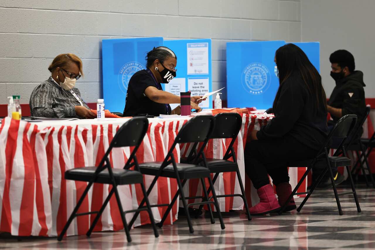 People check in as they prepare to cast their vote at the C.T. Martin Natatorium and Recreation Center on 5 January, 2021 in Atlanta, Georgia.