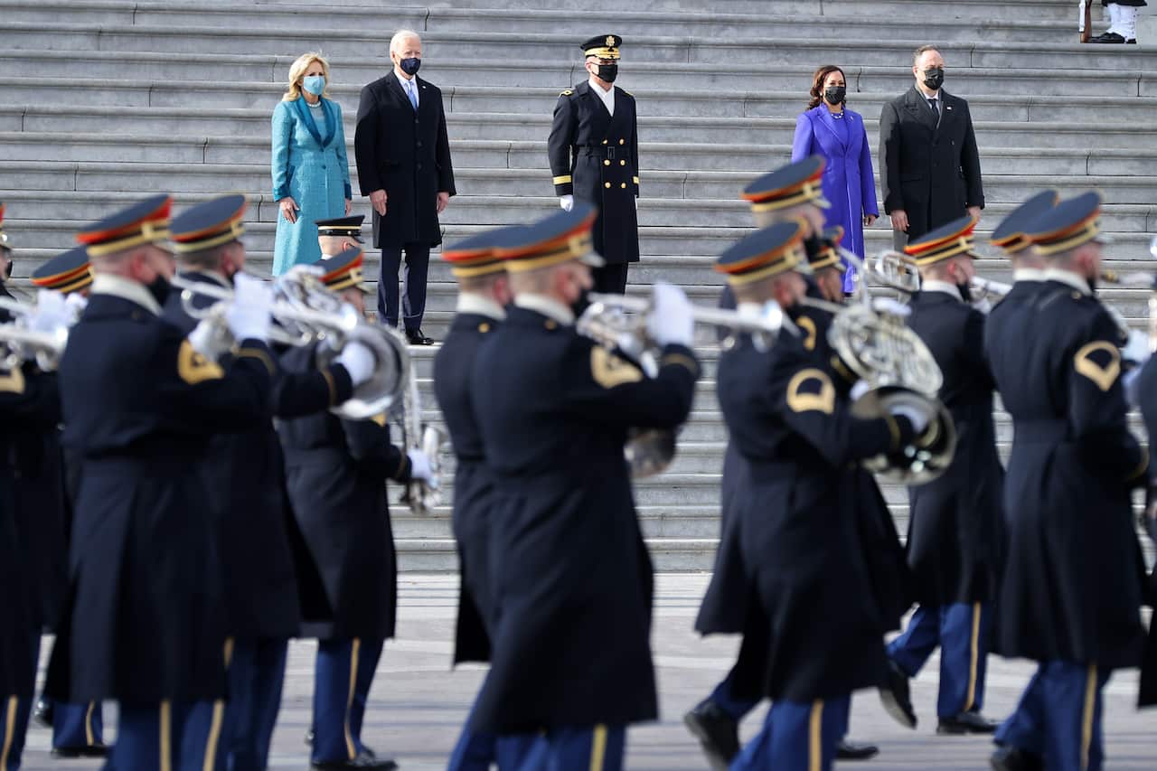 The new President of the United States watches the Pass in Review ceremony.