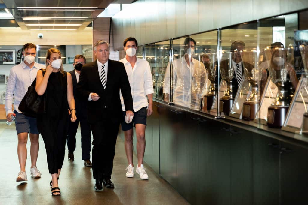 Eddie McGuire walks past premiership cups with his family ahead of a Collingwood Magpies AFL press conference on 9 February, 2021.
