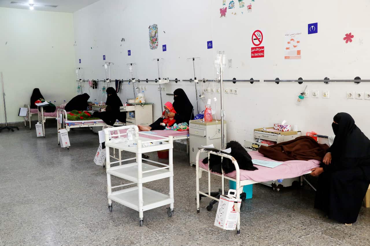 Mothers sit with their malnourished children as they receive medical treatment inside the pediatric ward to fight malnutrition at Al-Sabeen Hospital in Yemen.