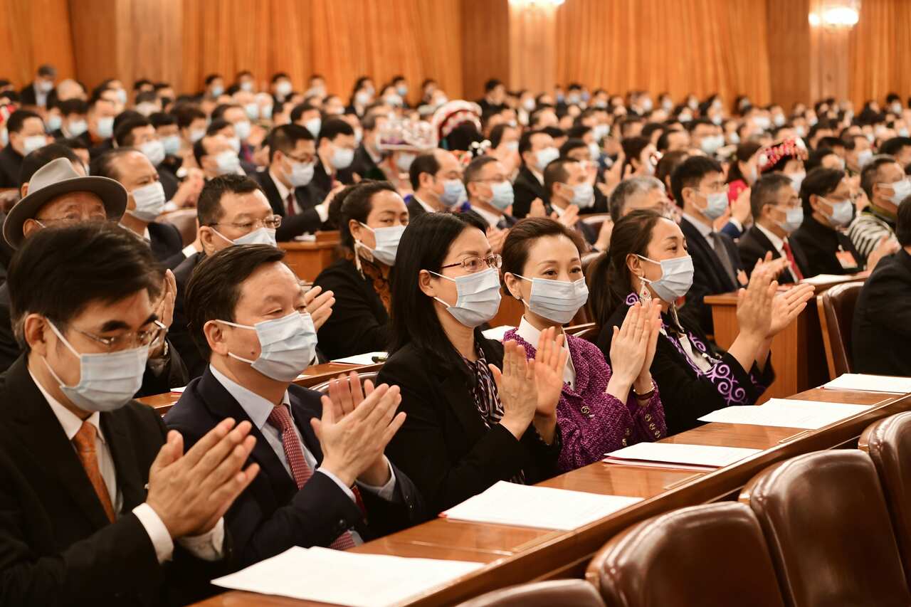 Deputies attend the closing meeting of the fourth session of the 13th National People's Congress at the Great Hall of the People in Beijing, China.