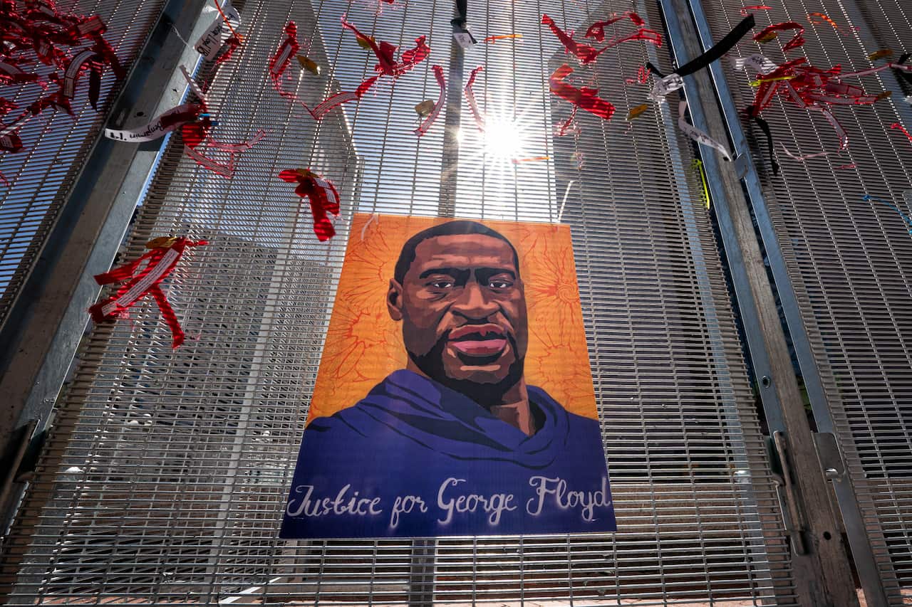 Posters are zip-tied to the security fence around the heavily secured Hennepin County Courthouse during the trial of Derek Chauvin. 