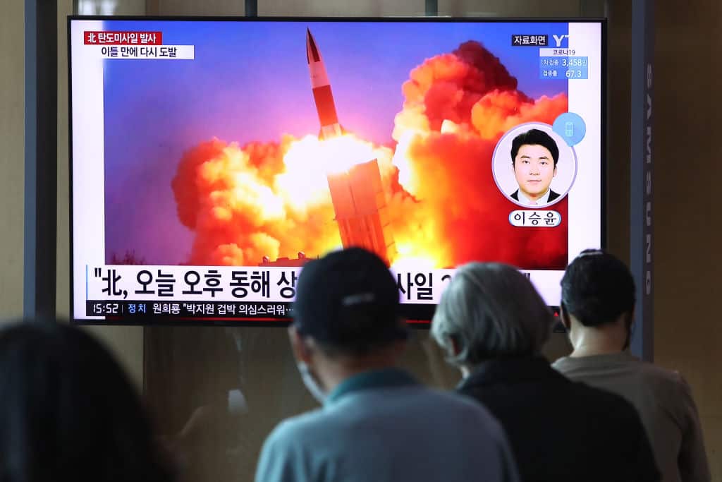 People watch a TV at the Seoul Railway Station showing a file image of a North Korean missile launch on 15 September 2021.