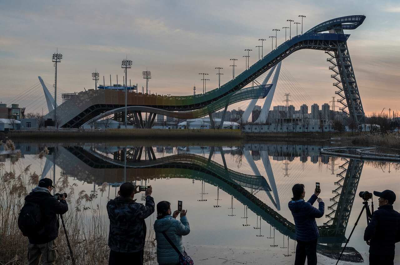 Visitors look at the Big Air venue that will see competition in freestyle skiing and snowboarding for the Beijing 2022 Winter Olympics at Shougang.