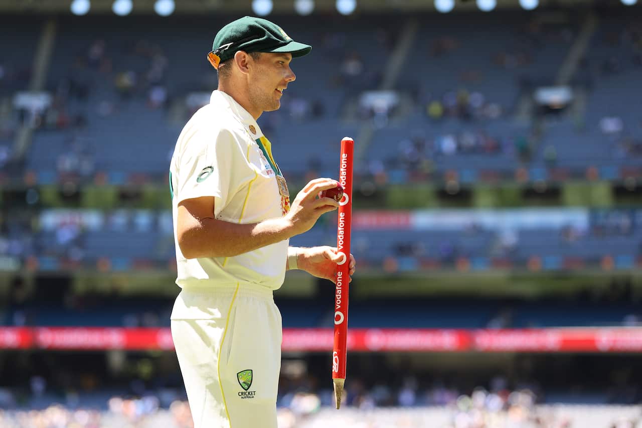 Scott Boland of Australia poses with the Johnny Muller medal, match ball and stump after winning and retaining the Ashes on 28 December.