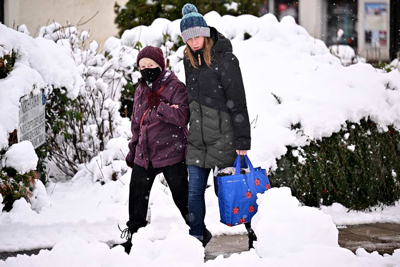 Members of the public walk through the snow in Auchterarder, Scotland on 18 February. 