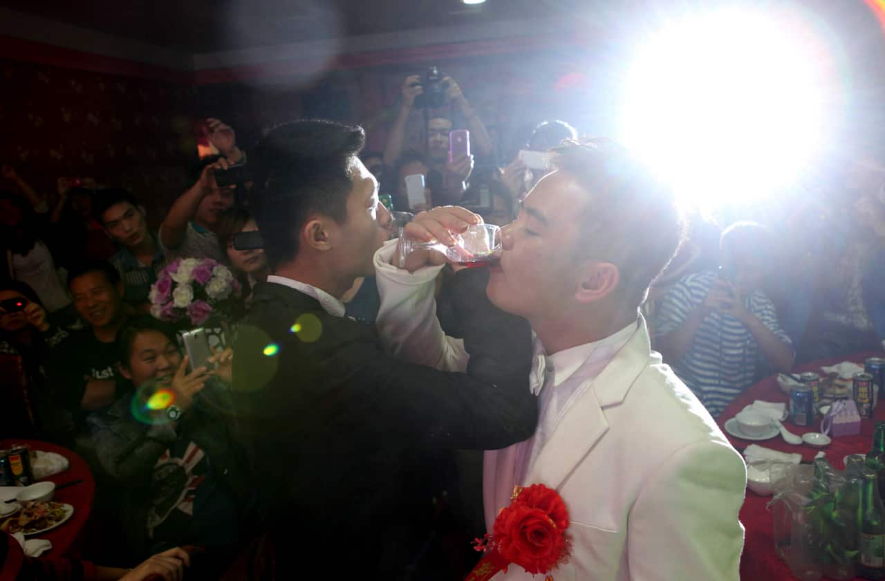 A Chinese couple toast each other during their 2012 public wedding ceremony at a hotel in Tuorong, in southeast China's Fujian province.  