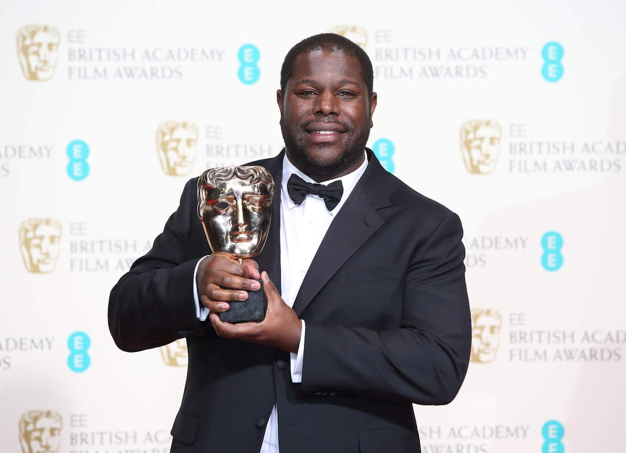 Steve McQueen poses at the 2014 BAFTA awards.