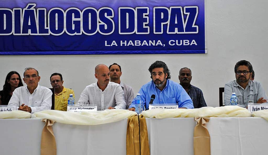 Cuban Rodolfo Benitez (3-R) and Norwegian Dag Nylander (2-L), guarantors in the FARC-EP and Colombian government peace talks, read a statement next to FARC-EP leftist guerrilla commander Ivan Marquez (R) and the head of the Colombian delegation Humberto d