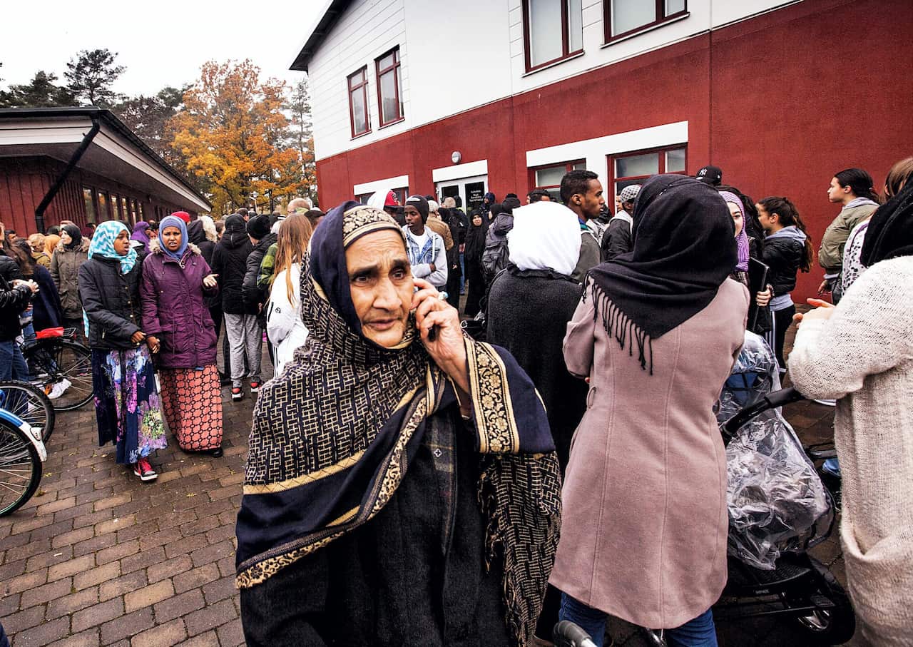 People and parents leaving school after attack at a primary and middle school in Trollhattan, southwestern Sweden, on October 22, 2015, where a masked man armed with a sword attacked students and staff members. (STR/AFP/Getty Images)