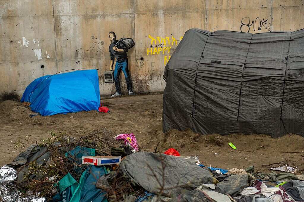 Street art graffiti representing Steve Jobs, founder and late CEO of Apple, by elusive British artist Banksy in Calais