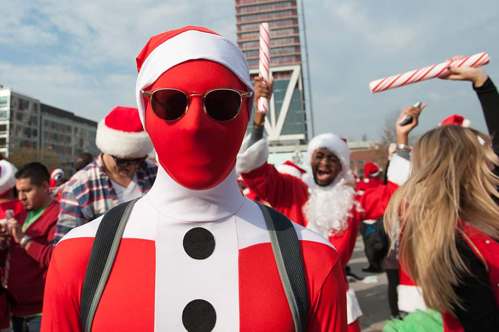 Hundreds of revelers take part in the holiday pub crawl, though some local bars and businesses have banned participants in an effort to avoid the typically rowdy SantaCon crowds.