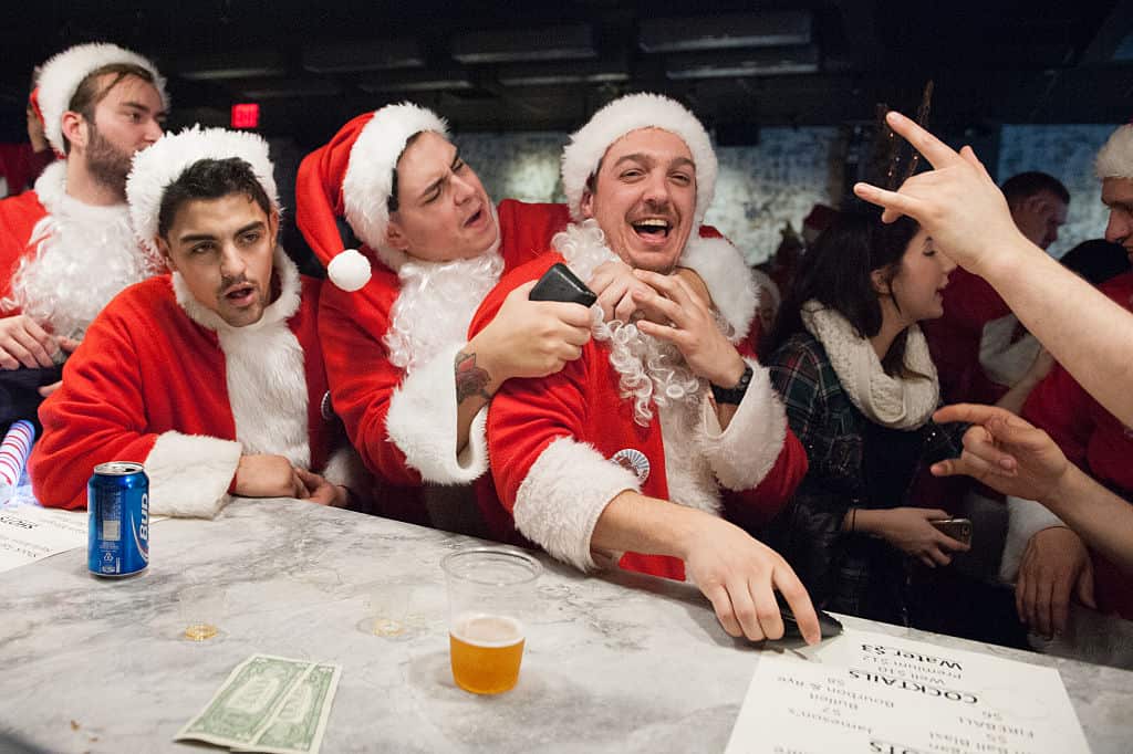 Men dressed as a Santa drink at a bar called The Hall during the annual SantaCon pub crawl 