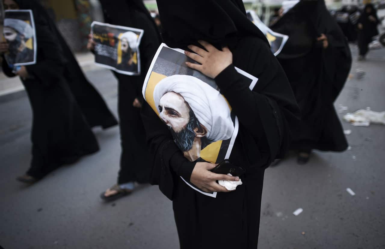 Bahraini women hold posters bearing portraits of prominent Shiite Muslim cleric Nimr al-Nimr during a protest against his execution by Saudi authorities, in 2016.