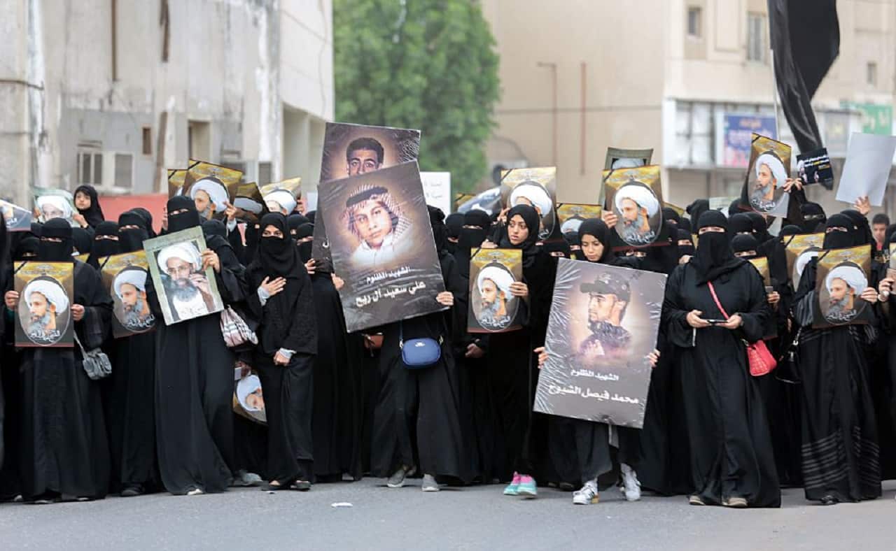 Saudi Shiite women hold placards bearing a portrait of Shiite Muslim cleric Nimr al-Nimr in the eastern coastal city of Qatif, January 2016.