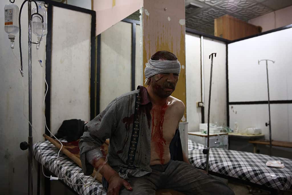 A man receives treatment at a make-shift hospital, following a reported airstrike on the besieged rebel-controlled city of Douma, a flashpoint near the Syrian capital on February 15, 2016. 
