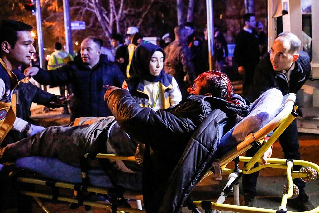 A wounded man is carried to an ambulance after an explosion on February 17, 2016 in Ankara, Turkey.
