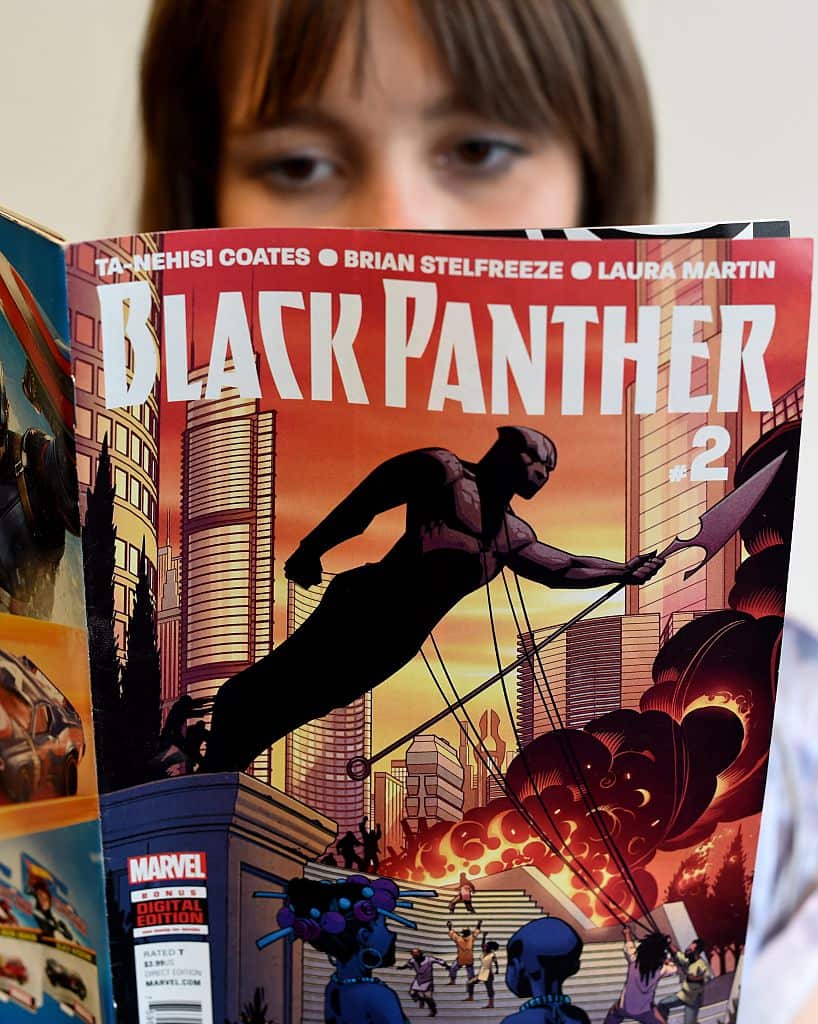 In this photo illustration a woman reads a copy of the Black Panther (T'Challa) a fictional superhero appearing in comic book published by Marvel Comics in New York May 17, 2016. Captain America and Iron Man may be the stars of Marvel's latest comic-book.
