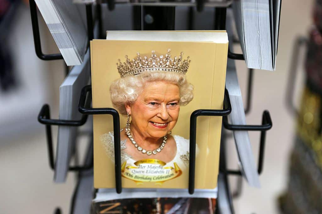 Postcards showing a smiling Queen are pictured in a souvenir shop in Oxford Circus in central London on June 8, 2016, as Britain prepares to celebrate the 90th birthday of Queen Elizabeth II.