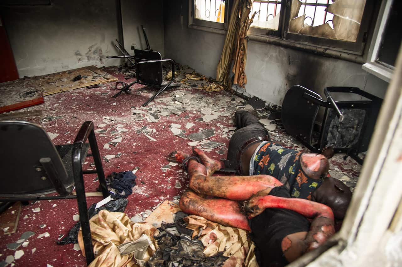 Bodies are photographed on September 20, 2016 in the offices of the main opposition Union for Democracy and Social Progress Party which were torched overnight.