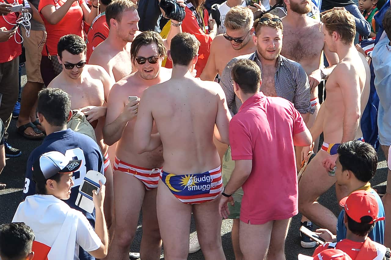 Australian spectators with swimwear bearing a Malaysian flag during the Formula One Malaysian Grand Prix in Sepang.