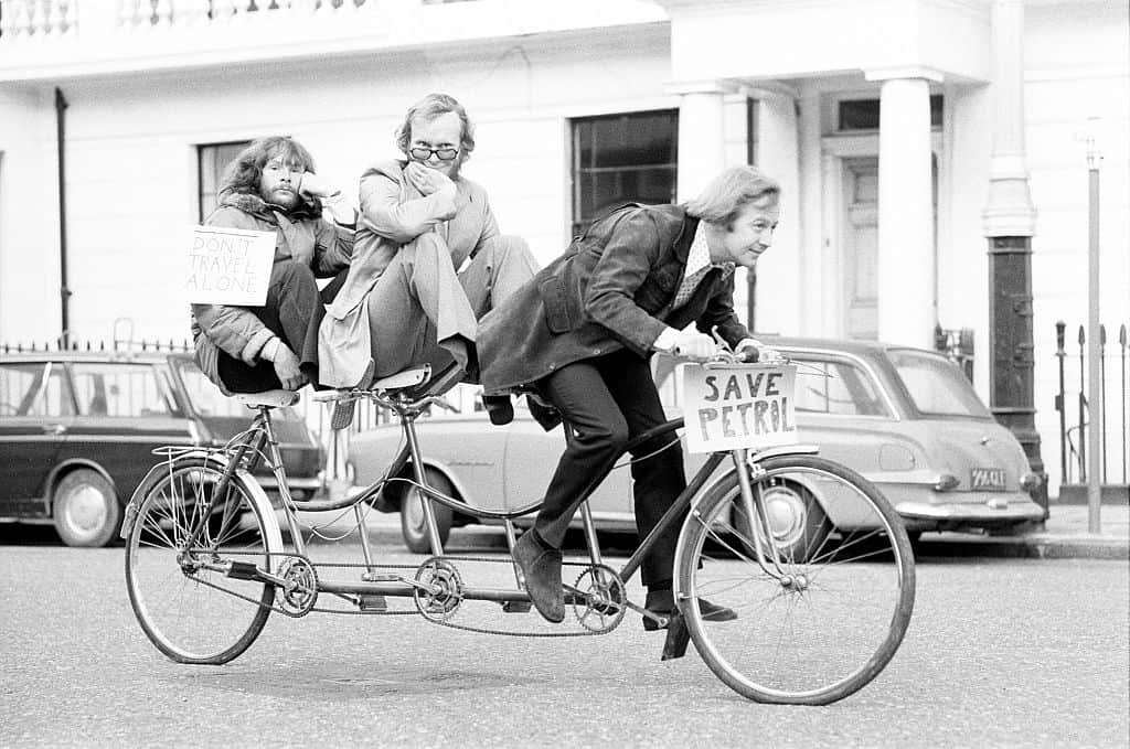 The Goodies, on the perfect answer to petrol rationing, ride their three seater tandem bicycle in London, Wednesday 21st
