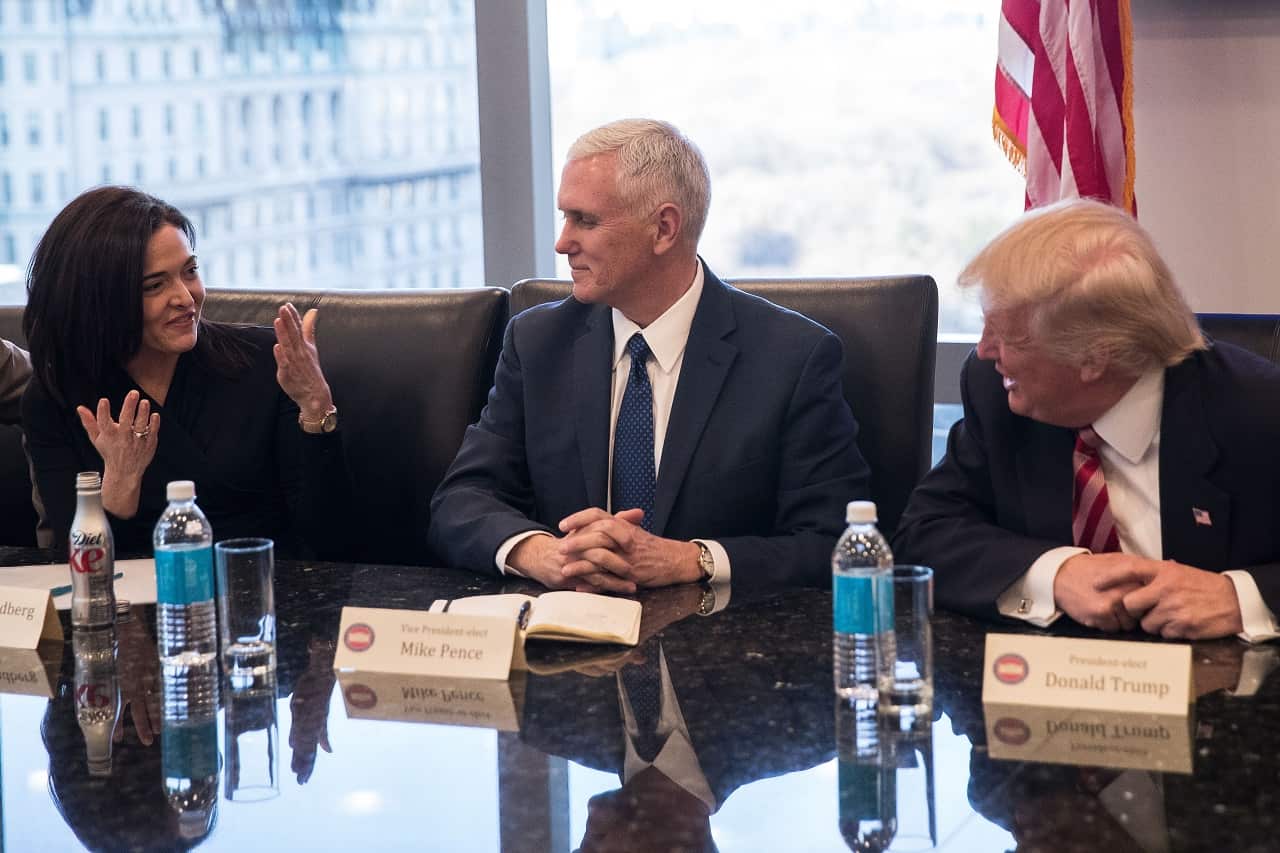 Sheryl Sandberg, COO of Facebook, speaks with  Vice President Mike Pence and President Donald Trump during a meeting of technology executives.