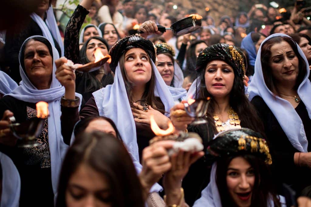 Iraqi Yazidis light candles and paraffin torches outside the Lalish temple situated in a valley near Dohuk northwest of Baghdad