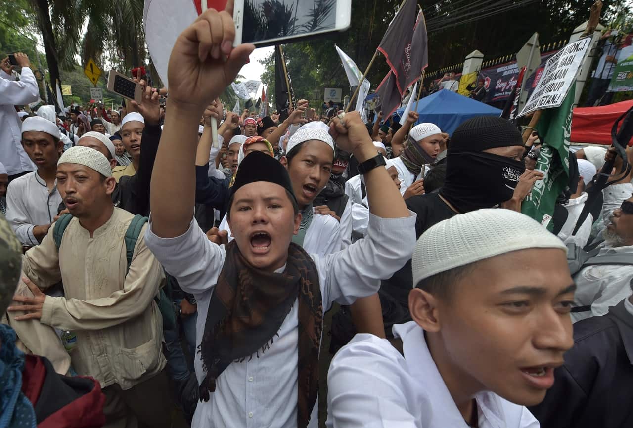 Protesters chant slogans against former Jakarta governor Basuki Tjahaja Purnama, who was jailed after being found guilty of blasphemy.