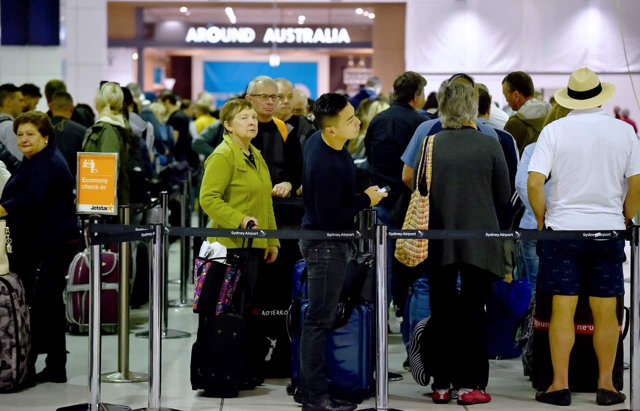 Passengers queue up at the international terminal in Sydney Airport.