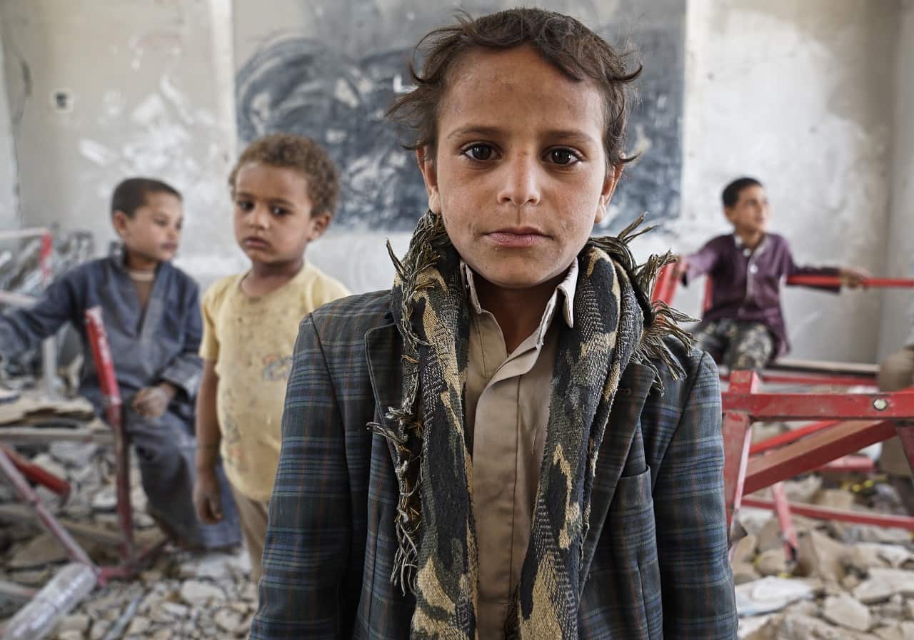 Young students sit in a former classroom at their local school in Saada City. Students now attend lessons in UNICEF tents.