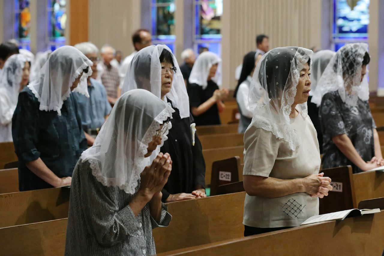Christians pray for victims during a mass to mark the anniversary of the atomic bombing at the Urakami Cathedral.