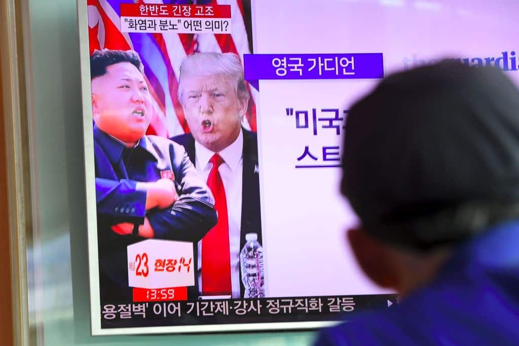 A man watches a TV news programme featuring Donald Trump and Kim Jong-Un in Seoul, South Korea in August 2017.