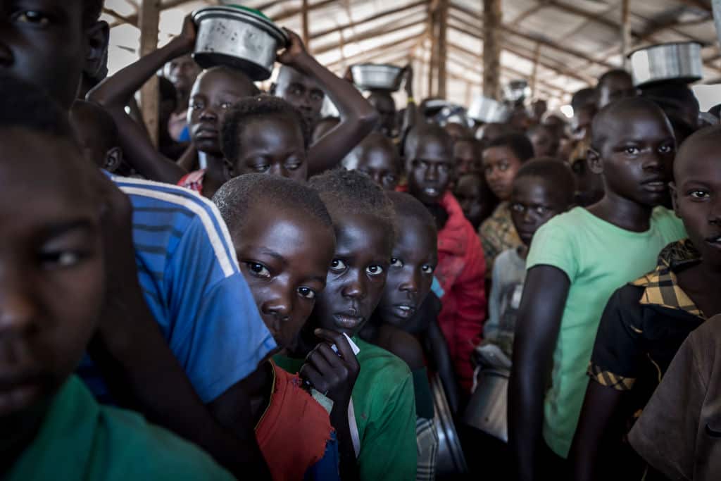 South Sudanese refugees queue for food in a camp in Uganda.