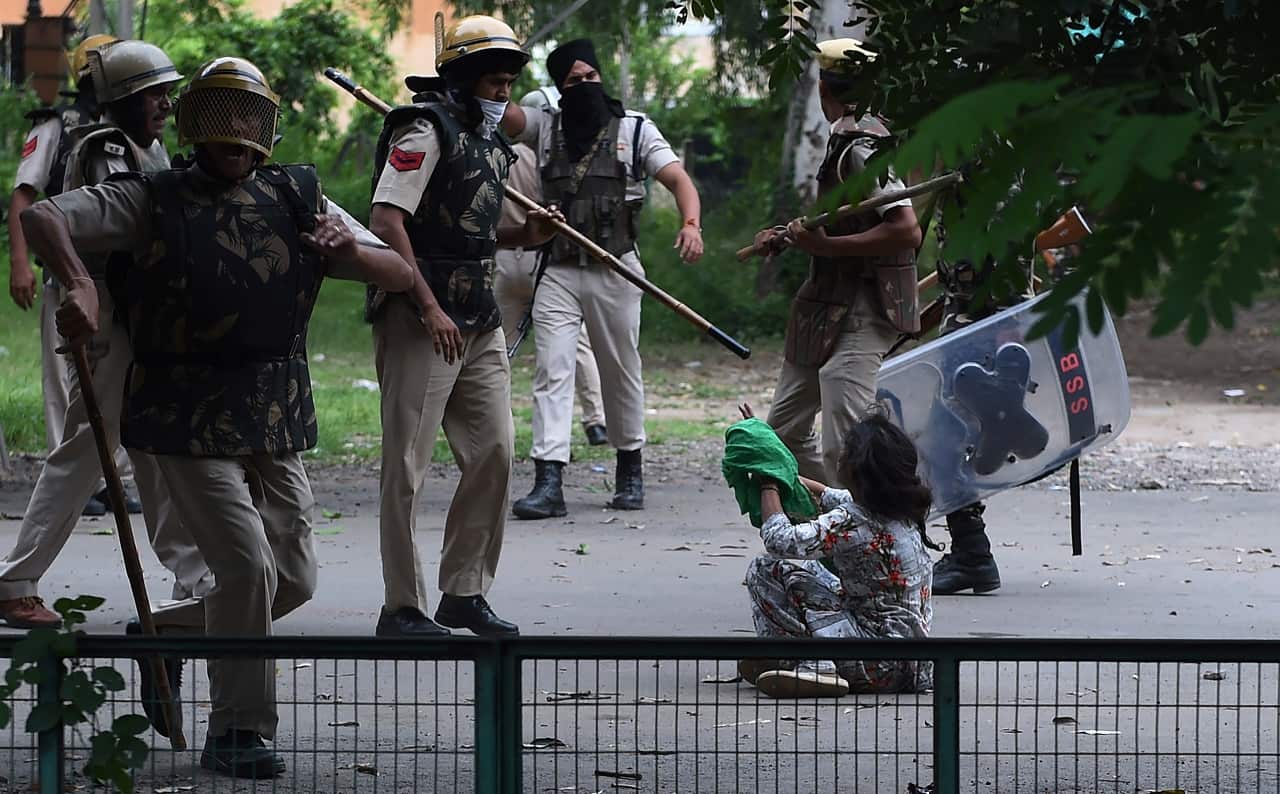 A follower of Indian religious leader Gurmeet Ram Rahim Singh pleads for her safety during clashes between controversial guru's followers and security forces.