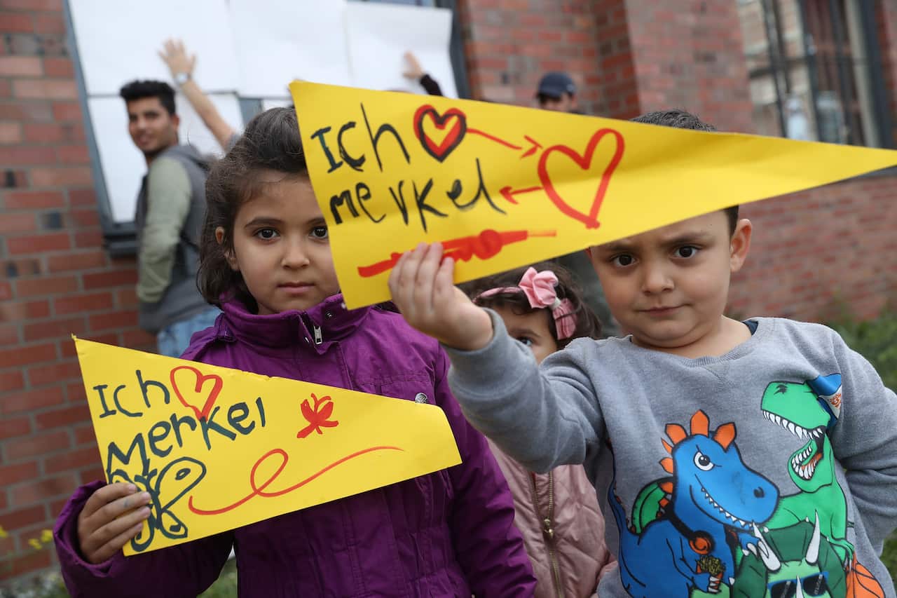 Children in Wismar, Germany, await a campaign visit from Angela Merkel in 2017. 