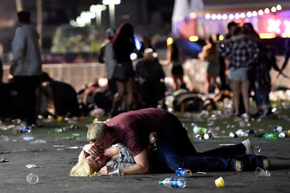 The haunting photo of a young man covering a woman from bullets during the Las Vegas massacre.