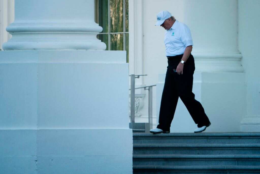 US President Donald Trump walks from the White House to his motorcade before traveling to his Virginia golf club on October 21, 2017.