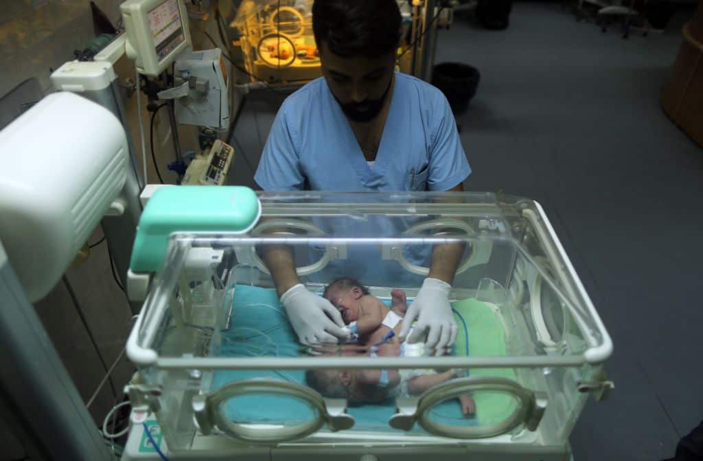 One-day-old Palestinian conjoined twins lie in an incubator at the nursery on October 22, 2017 at al-Shifa Hospital in Gaza City. / AFP PHOTO / MAHMUD HAMS        (Photo credit should read MAHMUD HAMS/AFP/Getty Images)