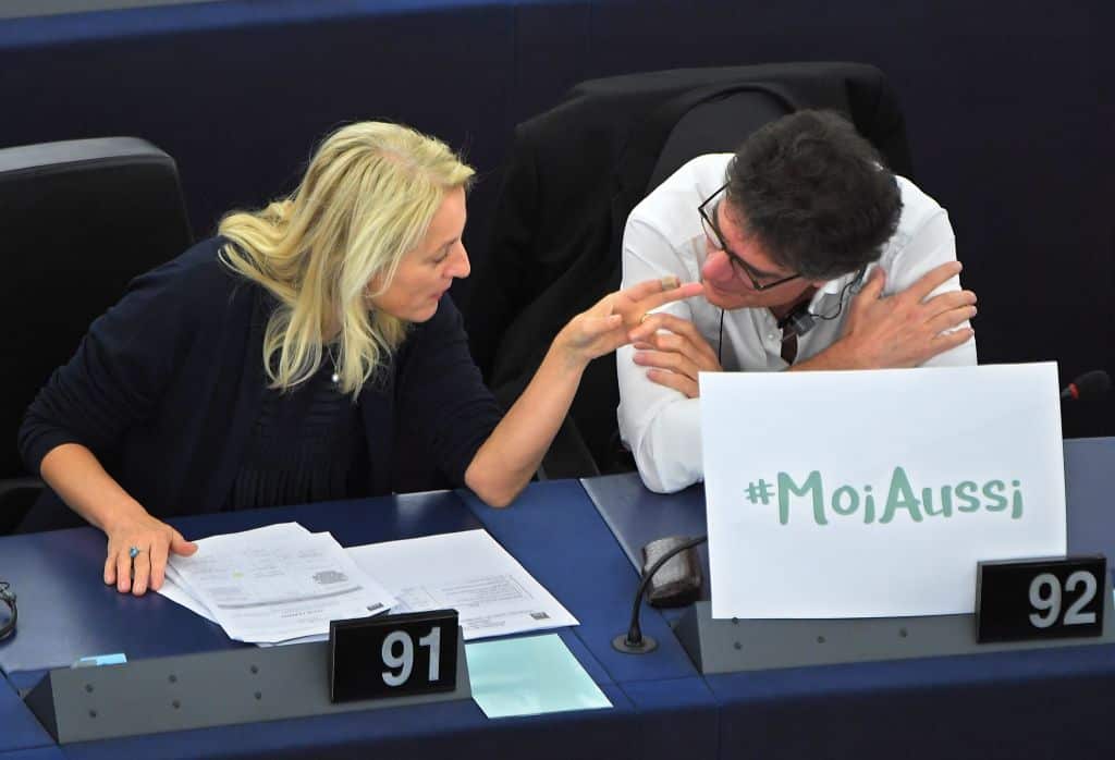 Austrian member of the European Parliament, Evelyn Regner (L) and French member of the European Parliament Patrick Durand, talk behind placard reading "Me too".