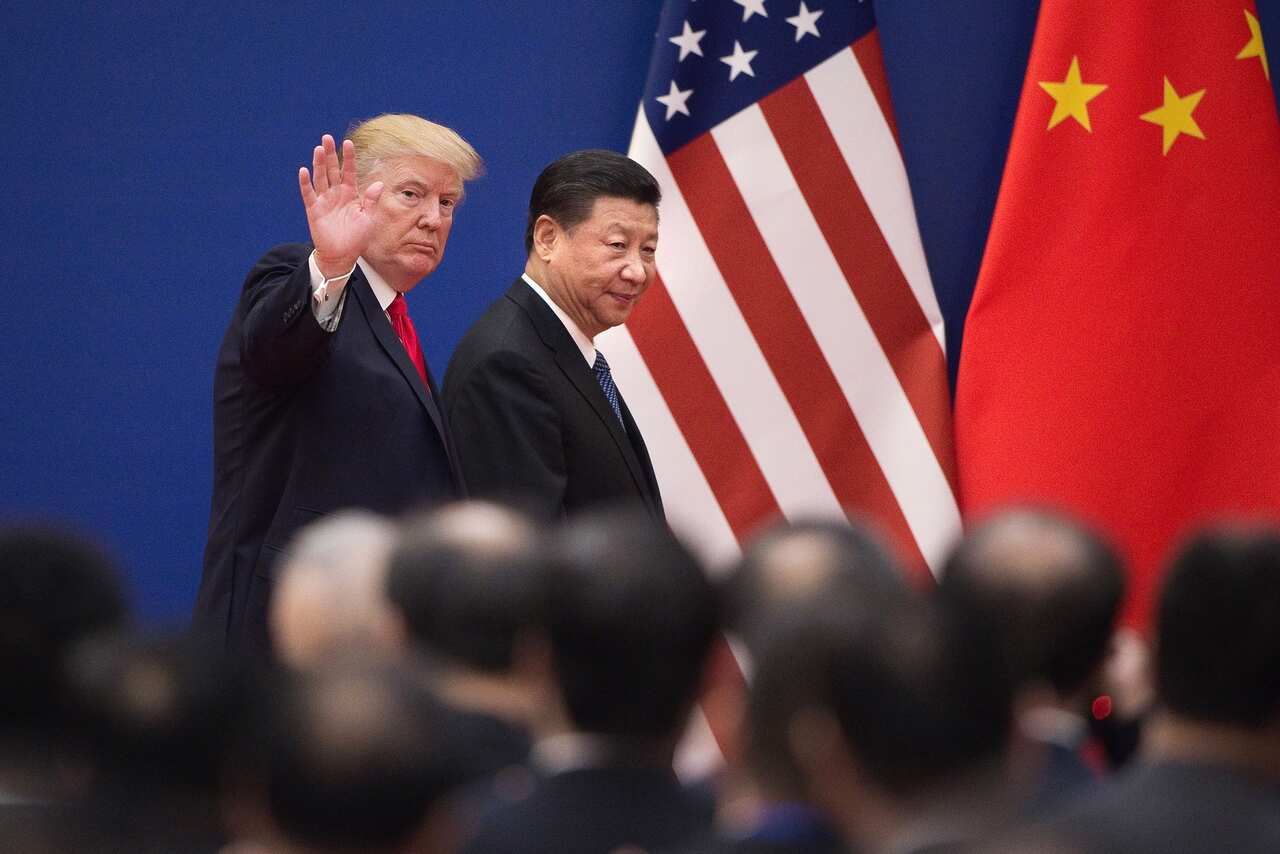US President Donald Trump (L) and China's President Xi Jinping leave a business leaders event at the Great Hall of the People in Beijing.
